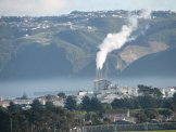 Smokestack vents fairly vertically in the mid-day calm.