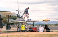 The sun drives even the airfield crew to sheltering in the underwing shade of the Albatross. (72Kb jpeg)