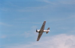 North American Harvard 2A, with the characteristic forward facing wheels in flight, doing a low flyby. (29Kb jpeg)