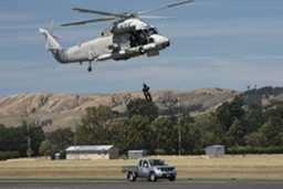 Seasprite helicopter winching a man up from a moving car. (295Kb jpeg)